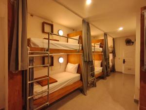 a group of bunk beds in a room at Lushy Hostel Kuta Legian in Legian +48 photos