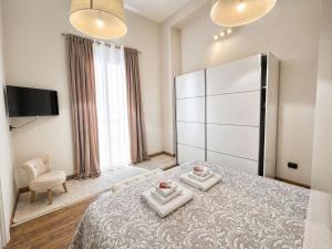 a bedroom with a bed with two towels on it at Albachiara Apartment in Lampedusa