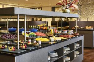 a buffet with many different types of food on display at NH Berlin Alexanderplatz in Berlin
