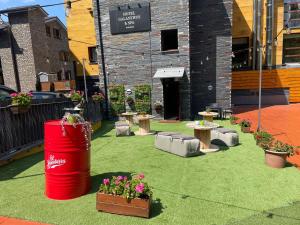 a patio with flowers and tables and a building at Wuau! Hotel Galanthus & Spa in Soldeu