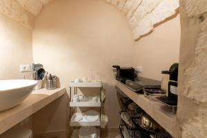 a bathroom with a sink and a counter at Ostuni Luxury Stay - 2 Jacuzzi in Ostuni +57 photos