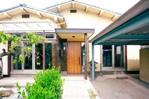 a house with a wooden door in front of it at 碧 AO Antik&Bay in Takamatsu