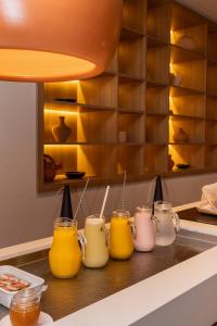 a counter with several different colored jars on it at Kennedy Slim Hotel in São José