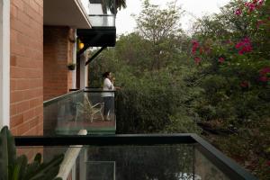 a woman standing on the balcony of a house at LiveAway Bengaluru, HSR by PACK in Bangalore