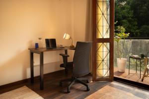 an office with a desk with a computer and a chair at LiveAway Bengaluru, HSR by PACK in Bangalore