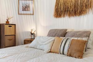 a bed with two pillows on it in a bedroom at Le Cocon d'Eymet village in Eymet