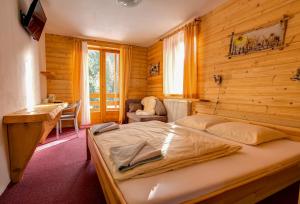 A bed or beds in a room at Penzion Limba
