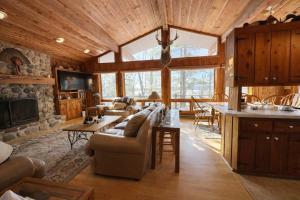 a living room with a couch and a table at Stack's Back Bay Retreat in Minocqua