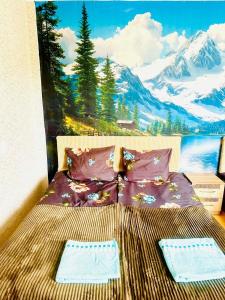 a bed in a room with a painting on the wall at Budget Home in Kutaisi