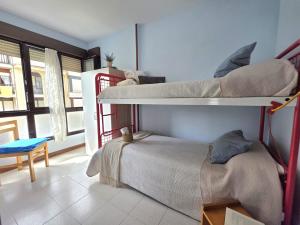 a bedroom with two bunk beds in a room at Apartamento Candela 6904 in Noja