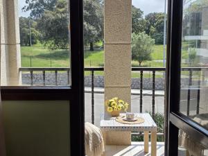 a room with a table and a view of a balcony at Apartamento Candela 6904 in Noja