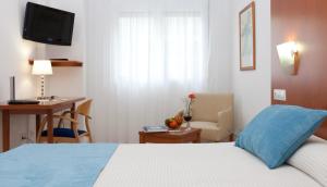 Postel nebo postele na pokoji v ubytování Hotel Verol