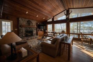 a living room with a couch and a fireplace at Stack's Back Bay Retreat in Minocqua