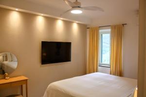 a bedroom with a bed and a flat screen tv at Casa Bruna in Levanto