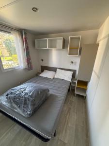 a small bedroom with a bed and a desk at Luberon Detente Mobile Home in Cheval-Blanc