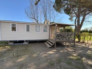 a house with a porch and a bench in front of it at Luberon Detente Mobile Home in Cheval-Blanc