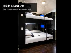 a couple of bunk beds in a room at Luxury Backpackers in Port Elizabeth
