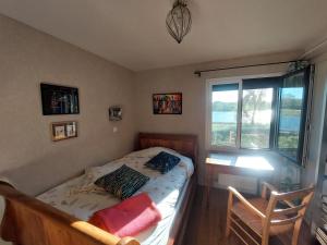a bedroom with a bed and a desk and a window at maison caroline bairon in Le Chesne