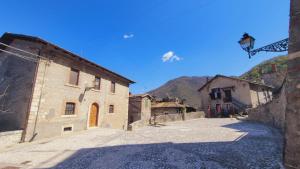 an empty street in a village with a building at B&B XXIV Maggio in Rocca di Botte