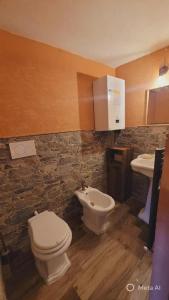 a bathroom with a toilet and a sink at B&B XXIV Maggio in Rocca di Botte