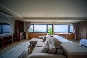 a large living room with a couch and a tv at 九份觀海樓民宿 in Jiufen