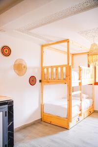 a bedroom with bunk beds in a room at Salty Life Surf House in Imsouane +91 photos