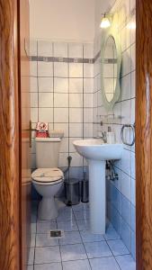 a bathroom with a toilet and a sink at Maison De La Mer in Paleo Tsifliki +34 photos