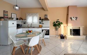 a kitchen with a table and chairs in a room at Maison De La Mer in Paleo Tsifliki