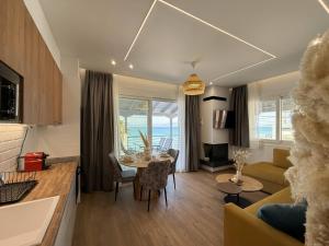 a kitchen and living room with a table and a couch at Blue Tree Suites in Pefkochori