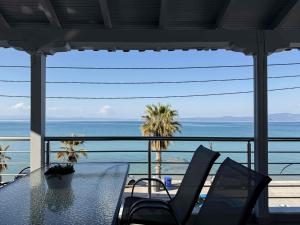 a table and chairs with a view of the ocean at Blue Tree Suites in Pefkochori