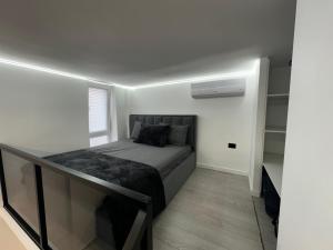 a small bedroom with a bed and a tv at Vila Calm in Pogradec