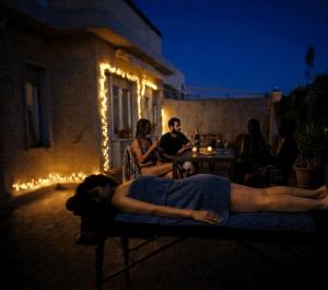 a man laying on a bed in the dark at TCEM camera in attico 6 no ascensore in Piombino
