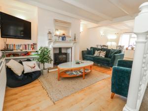a living room with a couch and a fireplace at September Cottage in Weymouth