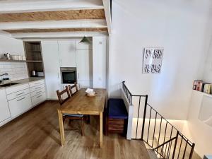 a kitchen and dining room with a wooden table at Casa a 20 minuts de Barcelona in Molins de Rei