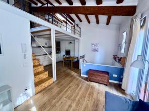 a living room with a staircase and a dining room at Casa a 20 minuts de Barcelona in Molins de Rei