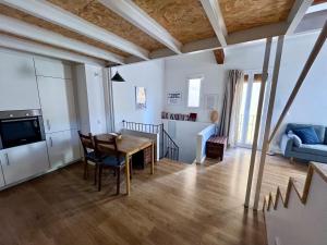 a living room with a wooden table and a blue couch at Casa a 20 minuts de Barcelona in Molins de Rei