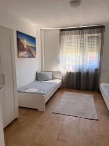 a small room with a bed and a window at Ferienwohnung Landskrone in Oppenheim +13 photos