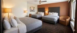 a hotel room with two beds and a chair at Quality Inn Lamar in Lamar