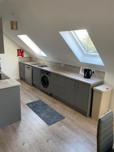 a kitchen with a sink and a washing machine at The Stables Apartment in Midleton +10 photos