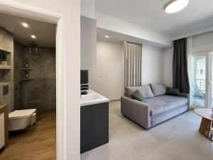a living room with a couch and a sink at Blue Tree Suites in Pefkochori +291 photos
