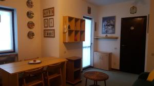 スコペッロにあるAppartamento Antaresのテーブルと椅子、窓が備わる客室です。