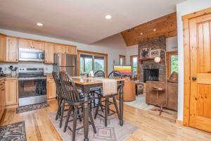 a kitchen with a table and chairs in a room at Above It All in Townsend