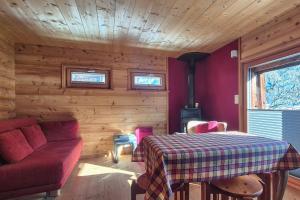 a living room with a red couch and a table at Stadel de Riedmatten in Reckingen - Gluringen