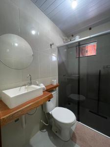 a bathroom with a toilet and a sink and a shower at POUSADA ORTEGA in Bodoquena +9 photos