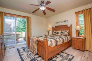a bedroom with a bed and a ceiling fan at Above It All in Townsend