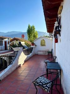 a patio with two chairs and a table on a balcony at Hostal Andino - Adults Only in Cafayate +21 photos