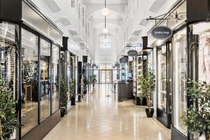 a hallway of a store with potted plants at Best Western ToRVEhallerne in Vejle