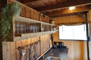 a kitchen with wooden walls and a sink and a counter at F1 Weekend House Close to Spa 6 Guests Doc in Amblève