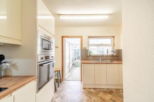 a kitchen with white cabinets and a sink at 2 Bed in Dalrymple oc-b40270 in Dalrymple +18 photos