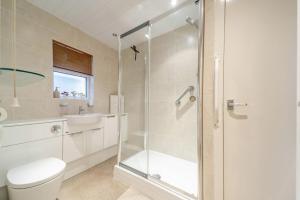 a bathroom with a shower and a toilet and a sink at 2 Bed in Dalrymple oc-b40270 in Dalrymple
